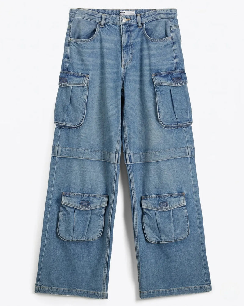 Close-up of multiple utility cargo pockets on women's baggy denim jeans