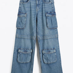 Close-up of multiple utility cargo pockets on women's baggy denim jeans